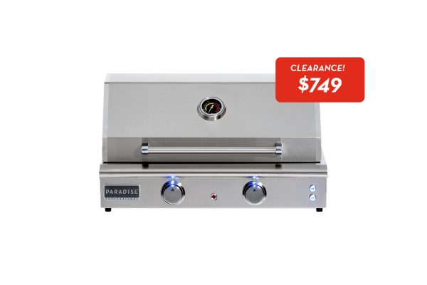An ESL - 24 Electric Grill featuring stainless steel, a closed lid, two control knobs, and blue indicator lights. Above it, a red "CLEARANCE! $749" sign is displayed on a white background.