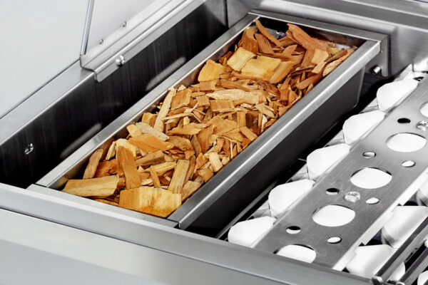 A stainless steel Wood Chip or Charcoal Smoker Grill Conversion filled with Wood chips.