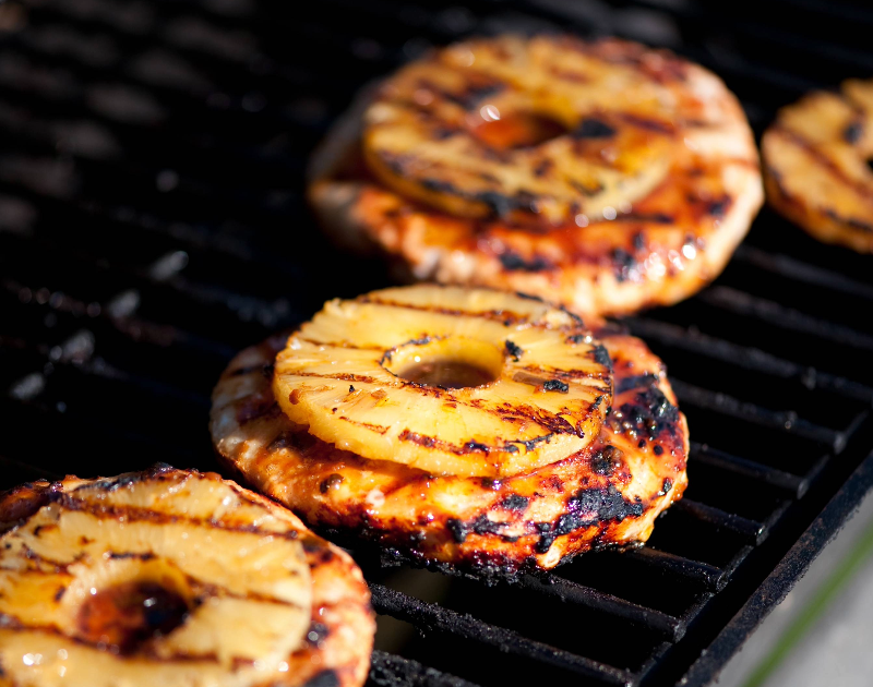 The photo depicts Burgers with pineapple on the Grill